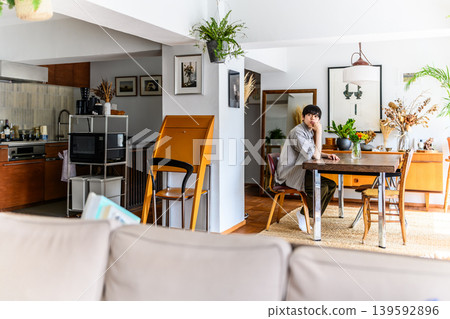 A man lost in thought in the dining room. A man lost in thought in the dining room. 139592896