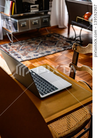 A laptop placed on a chair in the living room 139592907