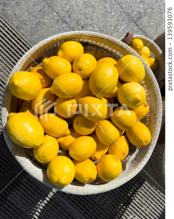 Fresh yellow lemons in a wicker basket, organic citrus harvested in the sun at an open market 139593076