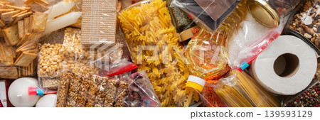 Canned goods, cereals, and pasta stored for quarantine and isolation, ensuring long-term survival and food security at home, survival during military operations, the concept of stay at home, banner Canned goods, cereals, and pasta stored for quarantine and isolation, ensuring long-term survival and food security at home, survival during military operations, the concept of stay at home, banner 139593129
