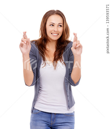 Fingers crossed, woman and hope in studio for luck, results and optimism on white background. Happy young model, thinking and wish for bonus giveaway, winning lottery prize or praying with emoji sign Fingers crossed, woman and hope in studio for luck, results and optimism on white background. Happy young model, thinking and wish for bonus giveaway, winning lottery prize or praying with emoji sign 139593571