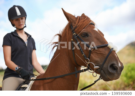 Equestrian, horse and woman riding in nature on adventure and journey in countryside. Ranch, animal and rider outdoor with hobby, sport or travel with pet on farm trail or girl in summer on blue sky Equestrian, horse and woman riding in nature on adventure and journey in countryside. Ranch, animal and rider outdoor with hobby, sport or travel with pet on farm trail or girl in summer on blue sky 139593600