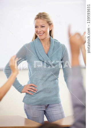 Hands in the air, woman and teacher with students, education and knowledge in a classroom. School, educator and kids with questions, answer and child development with a smile, learning and happiness Hands in the air, woman and teacher with students, education and knowledge in a classroom. School, educator and kids with questions, answer and child development with a smile, learning and happiness 139593631