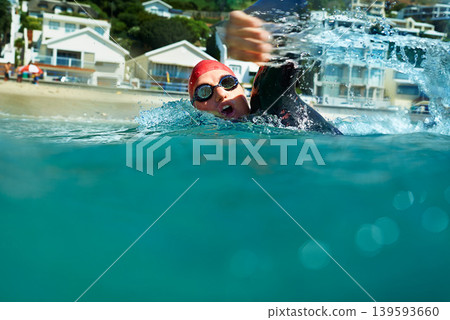 Swimming, crawl and person in ocean water in summer for exercise, training or workout on mockup space. Sea, sport and an athlete stroke outdoor for fitness, health and triathlon competition in nature 139593660