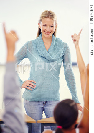 Hands in the air, woman and teacher with students, school and knowledge in a classroom. Learning, educator and kids with questions, answers and child development with a smile, learning and education 139593671