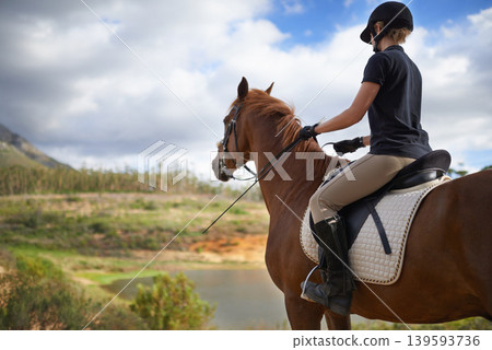 Equestrian, horse and woman riding in nature on adventure and journey in countryside. Ranch, animal and rider outdoor with hobby, sport or walking a pet on farm with girl in summer at river in woods Equestrian, horse and woman riding in nature on adventure and journey in countryside. Ranch, animal and rider outdoor with hobby, sport or walking a pet on farm with girl in summer at river in woods 139593736