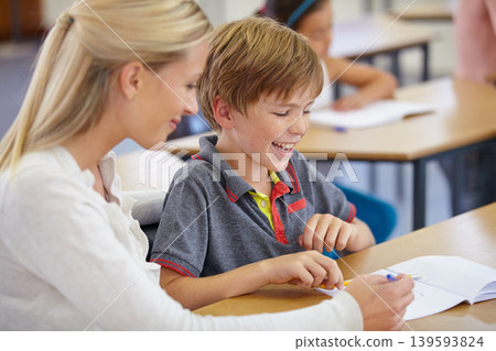 Teacher, children and writing in classroom for learning, education and writing or language development with support. Happy woman teaching, helping and student with knowledge or questions at school Teacher, children and writing in classroom for learning, education and writing or language development with support. Happy woman teaching, helping and student with knowledge or questions at school 139593824