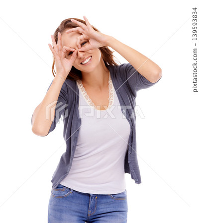 Portrait, fashion and finger glasses with woman in studio isolated on white background for silly style. Face, eyes and smile with happy young model in trendy, casual or relaxed clothes outfit Portrait, fashion and finger glasses with woman in studio isolated on white background for silly style. Face, eyes and smile with happy young model in trendy, casual or relaxed clothes outfit 139593834