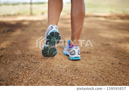 Person, feet and outdoor fitness in nature for exercise, wellness and running competition for cardio workout. Legs, training sneakers and jog in countryside with sport and strong for marathon in park Person, feet and outdoor fitness in nature for exercise, wellness and running competition for cardio workout. Legs, training sneakers and jog in countryside with sport and strong for marathon in park 139593857