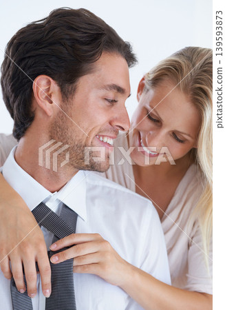 Smile, love and tie with couple dressing together in morning for help, romance or bonding. Fashion, style or clothes and businessman getting ready for work with wife in studio on white background Smile, love and tie with couple dressing together in morning for help, romance or bonding. Fashion, style or clothes and businessman getting ready for work with wife in studio on white background 139593873