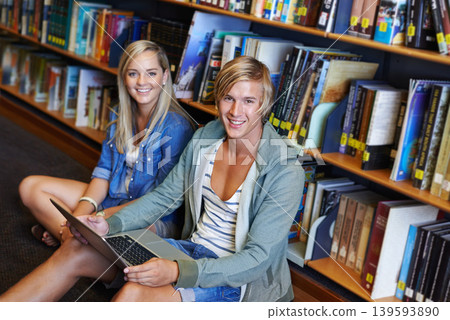 Teamwork, laptop or portrait of happy people in library at university, college or school campus for education. Bookshelf, elearning or students with scholarship studying research or online course 139593890