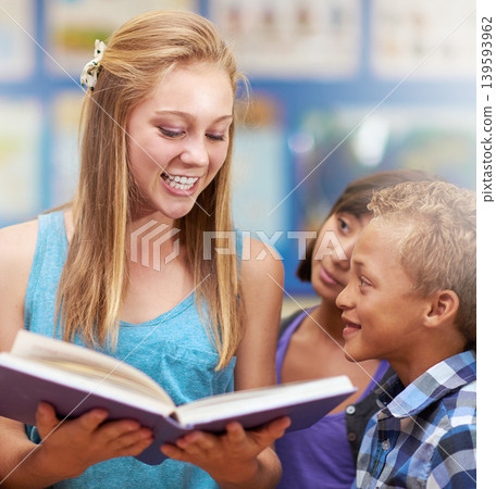 Children, tutor and reading a book in classroom for knowledge, learning or education with happiness. Group, student and scholar at school with study, textbook and smile with teacher and diversity 139593962