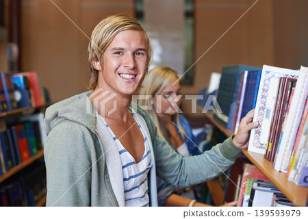 Portrait, book or happy man in library to search at university, college or school campus for education. Bookshelf, learning or student with scholarship studying knowledge, research and information Portrait, book or happy man in library to search at university, college or school campus for education. Bookshelf, learning or student with scholarship studying knowledge, research and information 139593979