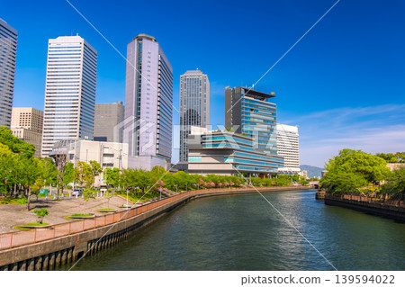 The cluster of skyscrapers in Osaka Business Park (OBP) viewed across the lush green Second Neyagawa River in Osaka City, Osaka Prefecture. The cluster of skyscrapers in Osaka Business Park (OBP) viewed across the lush green Second Neyagawa River in Osaka City, Osaka Prefecture. 139594022