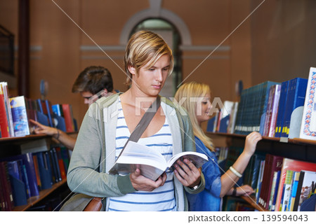 Reading book, knowledge or man in library at university, college or school campus for future education. Bookshelf, focus or male student with scholarship studying research or learning information Reading book, knowledge or man in library at university, college or school campus for future education. Bookshelf, focus or male student with scholarship studying research or learning information 139594043