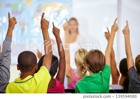 Back of students, classroom and raise hands for questions, education or learning with geography quiz in school. Youth, group or smart kids with teaching for support, class ideas and answer or advice Back of students, classroom and raise hands for questions, education or learning with geography quiz in school. Youth, group or smart kids with teaching for support, class ideas and answer or advice 139594080