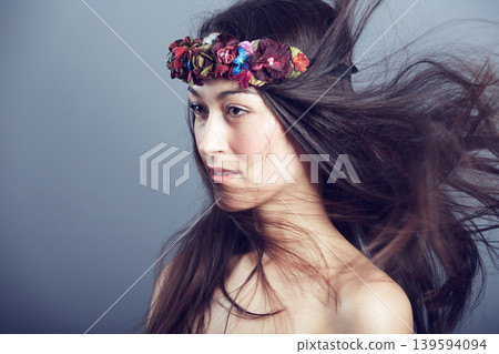 Woman, flower crown and wind in hair for beauty, skin glow and wellness on grey background. Keratin treatment, hairstyle with floral headband or accessory, dermatology and cosmetics in studio Woman, flower crown and wind in hair for beauty, skin glow and wellness on grey background. Keratin treatment, hairstyle with floral headband or accessory, dermatology and cosmetics in studio 139594094