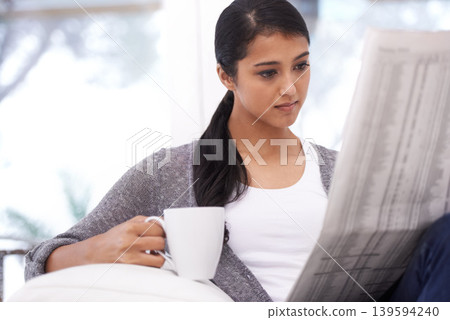 Woman, reading and newspaper with coffee in a home in the morning with story, article and news. Relax, press print and calm person from India with paper publication and tea in house with information 139594240