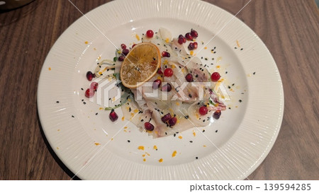 Fish carpaccio with cranberries, pomegranate, black sesame, and lemon zest Fish carpaccio with cranberries, pomegranate, black sesame, and lemon zest 139594285