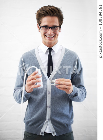 Business man, portrait and plug with cable, connection or smile for electricity by wall background. Person, employee or entrepreneur for electronics, wire or happy for power, energy and link at job Business man, portrait and plug with cable, connection or smile for electricity by wall background. Person, employee or entrepreneur for electronics, wire or happy for power, energy and link at job 139594361