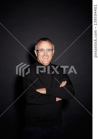 Portrait of mature man in studio with smile, arms crossed and happy with dark fashion style. Pride, relax and senior person isolated on black background with expert knowledge, glasses and wisdom. Portrait of mature man in studio with smile, arms crossed and happy with dark fashion style. Pride, relax and senior person isolated on black background with expert knowledge, glasses and wisdom. 139594401