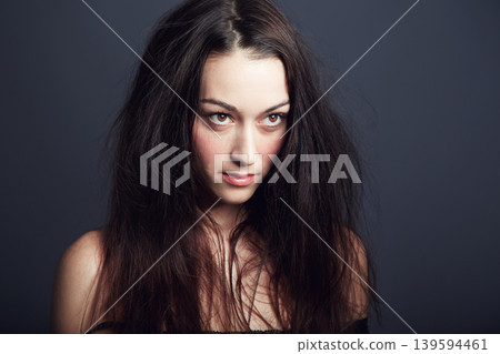 Woman, hair and beauty with confidence and cosmetic care in studio, wellness and long hairstyle on dark background. Empowered, fierce and edgy with young model and texture, growth and salon treatment 139594461