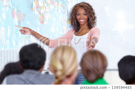 Happy woman, teacher and map for student question in classroom for education on geography at school. Female person, educator or lecturer smile with group of learners pointing to world for interaction Happy woman, teacher and map for student question in classroom for education on geography at school. Female person, educator or lecturer smile with group of learners pointing to world for interaction 139594485