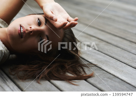 Woman, portrait and confident on porch for relax outdoor in backyard and break, lying down and rest in home. Person, face or calm on wooden deck in garden of house or apartment and carefree or casual Woman, portrait and confident on porch for relax outdoor in backyard and break, lying down and rest in home. Person, face or calm on wooden deck in garden of house or apartment and carefree or casual 139594747