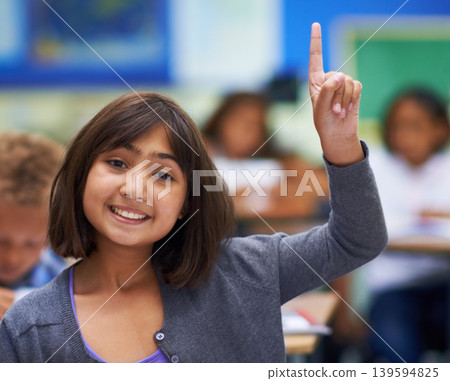 Girl, portrait and raise hand in classroom, elementary school and answer teacher question. Students, study and childhood development for education, knowledge and academic information for people 139594825
