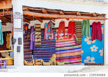 Colorful textiles displayed outside a local market in a village Capileira. Colorful textiles displayed outside a local market in a village Capileira. 139594869