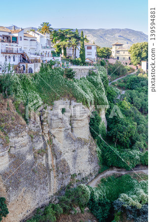 The picturesque town of Ronda in Spain is located on a cliff. The picturesque town of Ronda in Spain is located on a cliff. 139594881