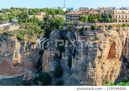 The picturesque town of Ronda in Spain is located on a cliff. 139594886