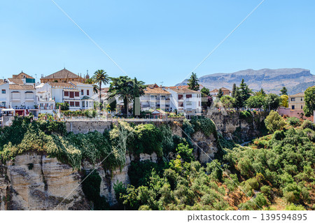 The picturesque town of Ronda in Spain is located on a cliff. The picturesque town of Ronda in Spain is located on a cliff. 139594895