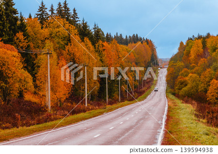 Scenic autumn road winding through colorful trees Scenic autumn road winding through colorful trees 139594938