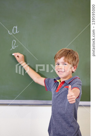 Portrait, child writing or thumbs up on chalkboard in classroom of elementary school. Boy, education student or happy kid with smile or hand gesture for like emoji, agreement or learning to write Portrait, child writing or thumbs up on chalkboard in classroom of elementary school. Boy, education student or happy kid with smile or hand gesture for like emoji, agreement or learning to write 139595000