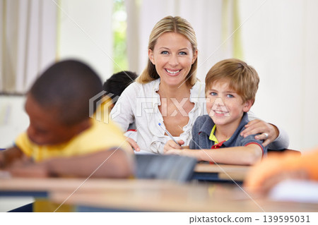 Portrait of happy teacher, child or writing in classroom for learning, education and helping for development. Woman teaching, hug or boy student with knowledge, support or notebook at middle school Portrait of happy teacher, child or writing in classroom for learning, education and helping for development. Woman teaching, hug or boy student with knowledge, support or notebook at middle school 139595031