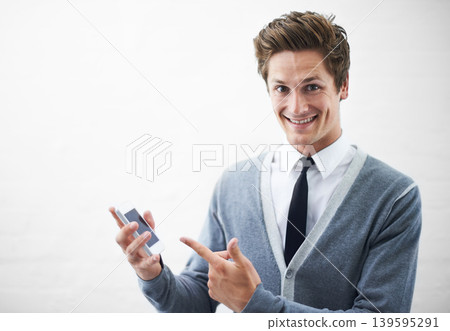 Business man, show phone and studio portrait with mockup space, pointing or happy by white background. Person, entrepreneur and tech startup employee in presentation, choice and smartphone with pride Business man, show phone and studio portrait with mockup space, pointing or happy by white background. Person, entrepreneur and tech startup employee in presentation, choice and smartphone with pride 139595291