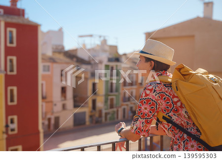 Woman strolls through colorful streets of Spanish coastal town 139595303