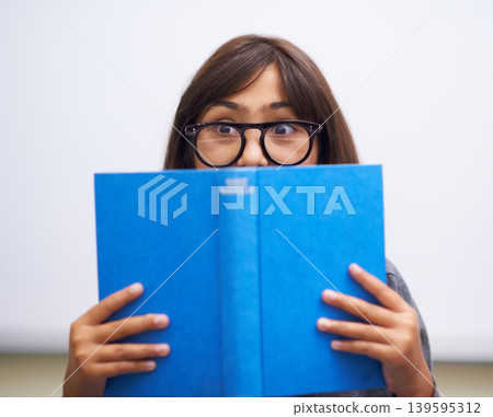 Student, child and hide face with book to read in front for classroom, shy and learning. Elementary school, girl kid and prepared oral with workbook, childhood development and academic education Student, child and hide face with book to read in front for classroom, shy and learning. Elementary school, girl kid and prepared oral with workbook, childhood development and academic education 139595312