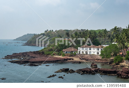 Guesthouses and palm trees on the coast of Goa India. Guesthouses and palm trees on the coast of Goa India. 139595488