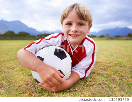 Happy, soccer player and ball with portrait, exercise and ready for game, field and child. Outdoor, playful and sport for childhood, smile and athlete for match, alone and outside on football pitch 139595729