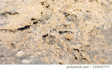 Close up view of textured sandy soil with small rocks and minerals Close up view of textured sandy soil with small rocks and minerals 139595777