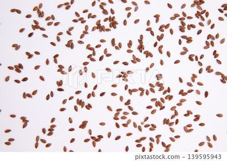 flax seeds scattered on white background flax seeds scattered on white background 139595943