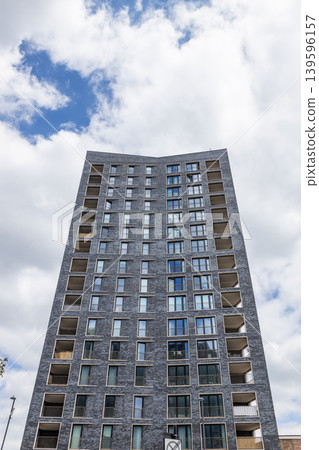 Low angle view of a tall concrete apartment tower in the city 139596157