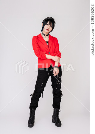 A female model in a red jacket with a rock-inspired style. A female model in a red jacket with a rock-inspired style. 139596208
