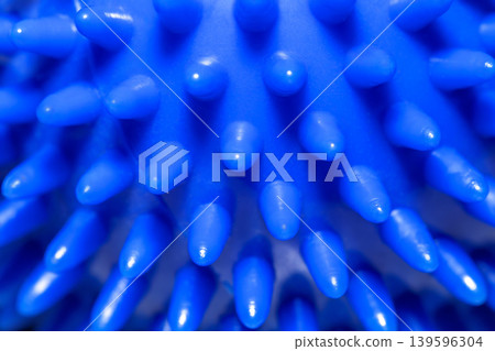 Blue massage spiky ball for fitness and physiotherapy macro 139596304