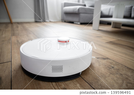 Robot vacuum cleaner cleaning wooden floor Robot vacuum cleaner cleaning wooden floor 139596491