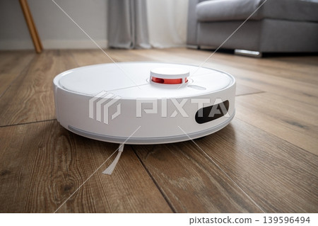 Robot vacuum cleaner cleaning wooden floor Robot vacuum cleaner cleaning wooden floor 139596494