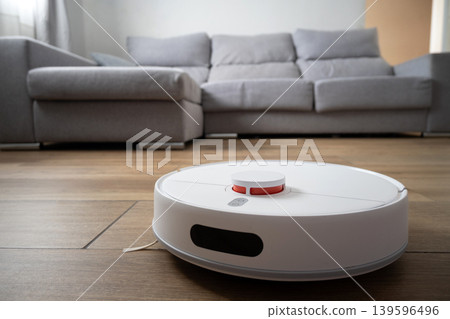 Robot vacuum cleaner cleaning wooden floor Robot vacuum cleaner cleaning wooden floor 139596496