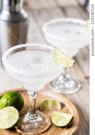Classic margarita cocktail with lime and salt rim Classic margarita cocktail with lime and salt rim 139596529